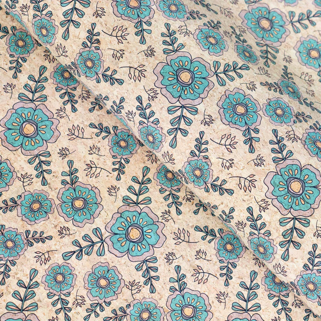 Élégance botanique : motif floral bleu sarcelle et vert sur un support en liège